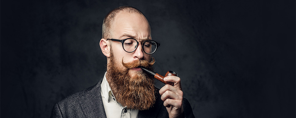 Man with glorious beard smoking a tobacco pipe